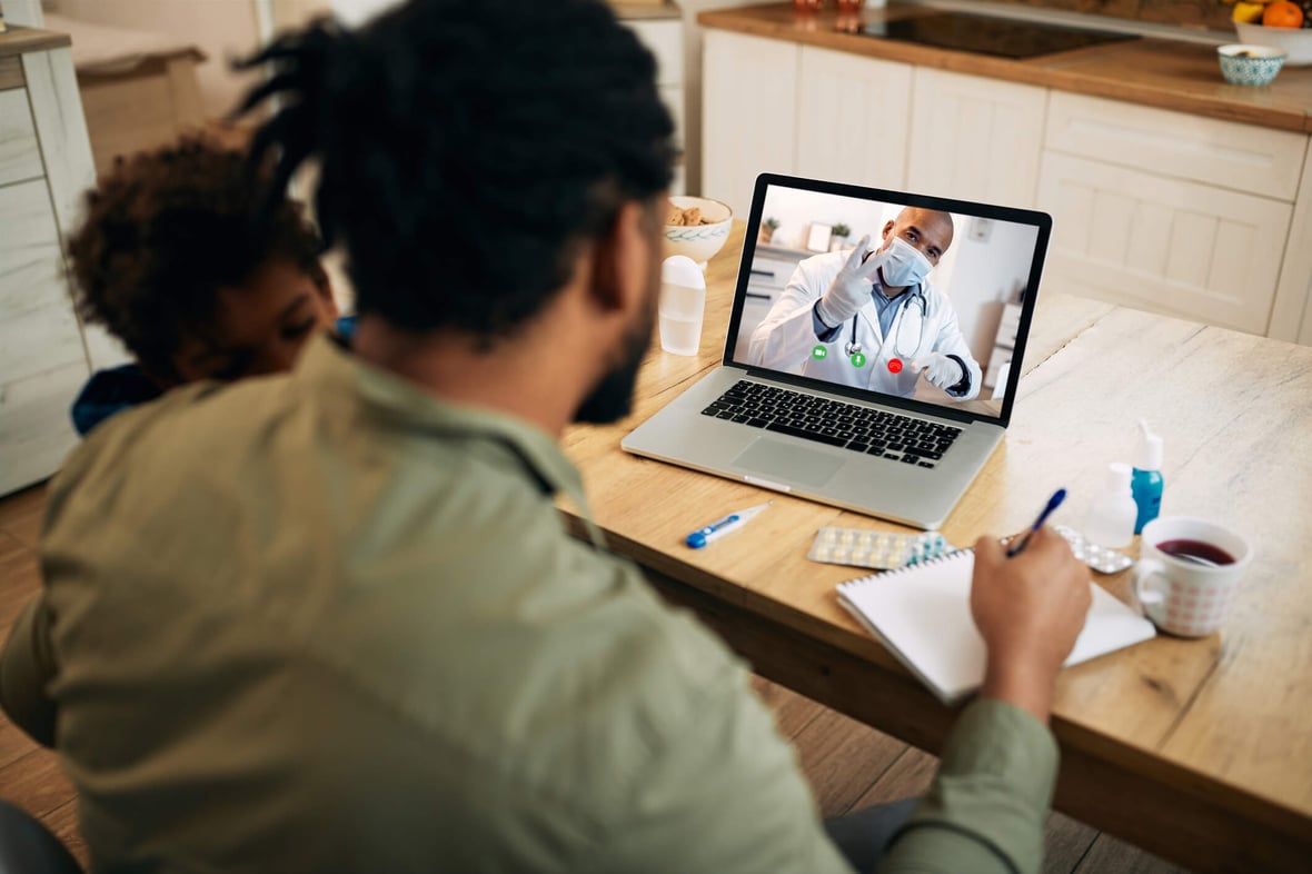 Marketer looking at a computer with the screen showing a healthcare professional