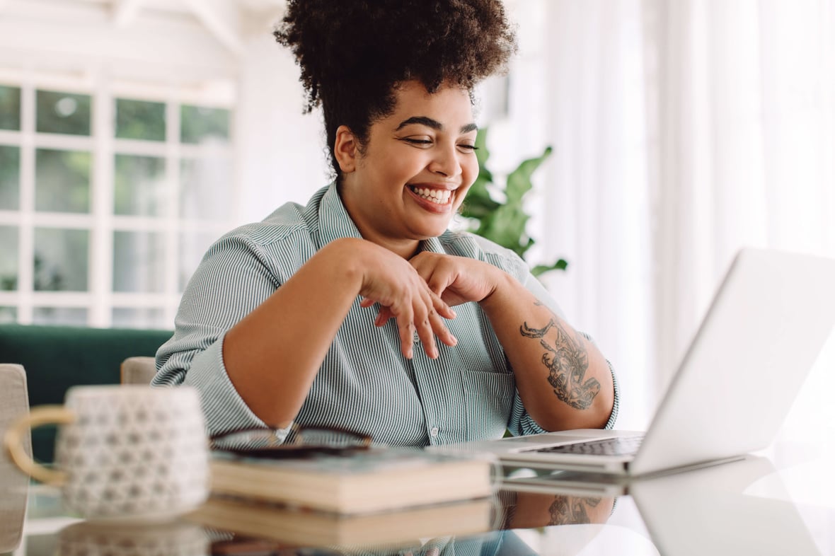 African American Women  Laughing While Looking at a Computer Screen 