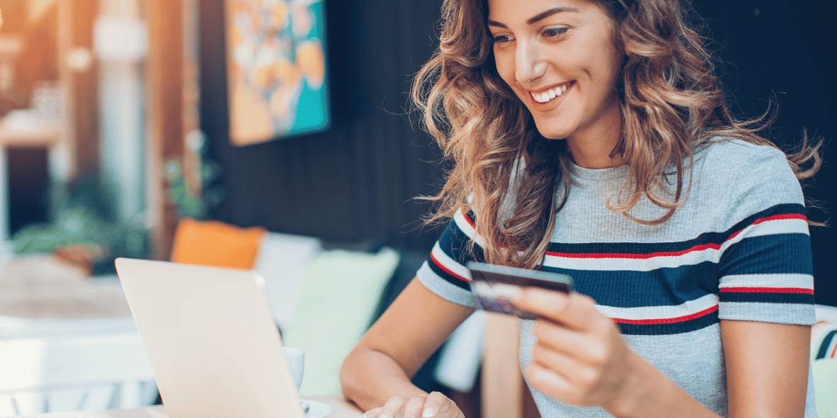 Woman smiling with credit card in hand