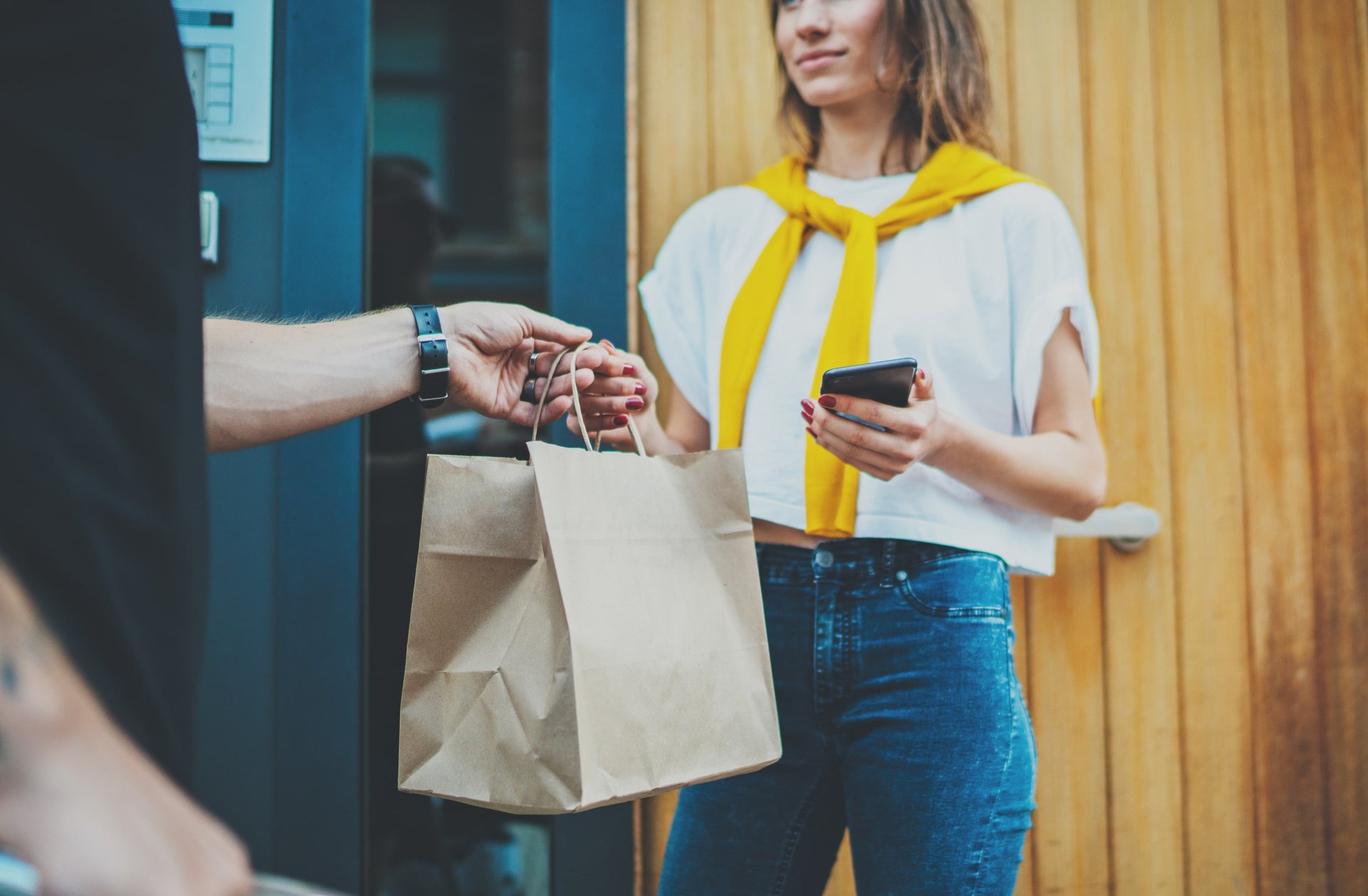 handing a shopping bag to a customer