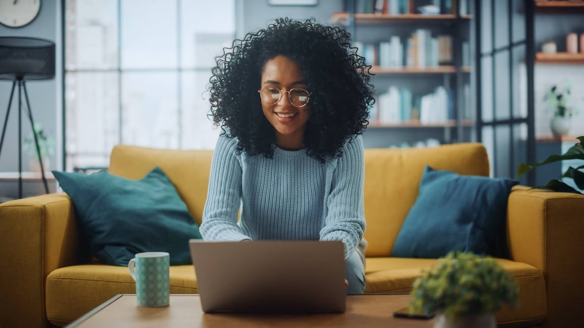 Female in a Stylish Cozy Living Room Using Laptop Computer at Home