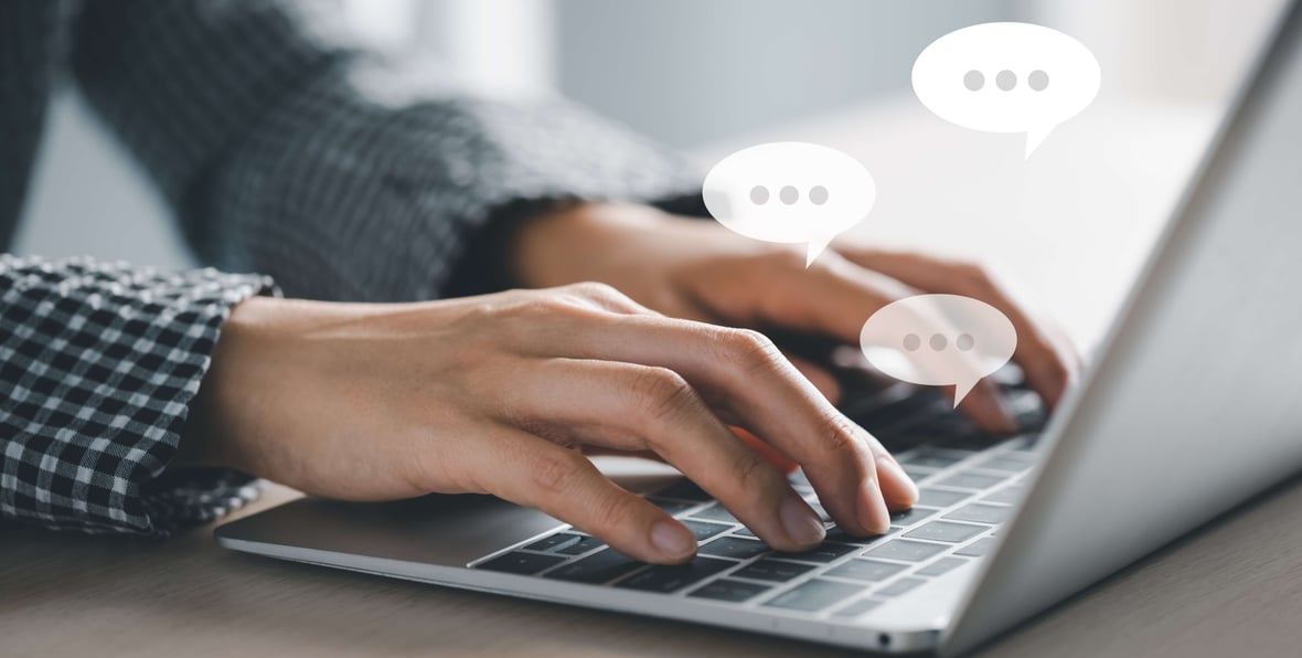 Zoomed in photo of two hands typing in a laptop keyboard