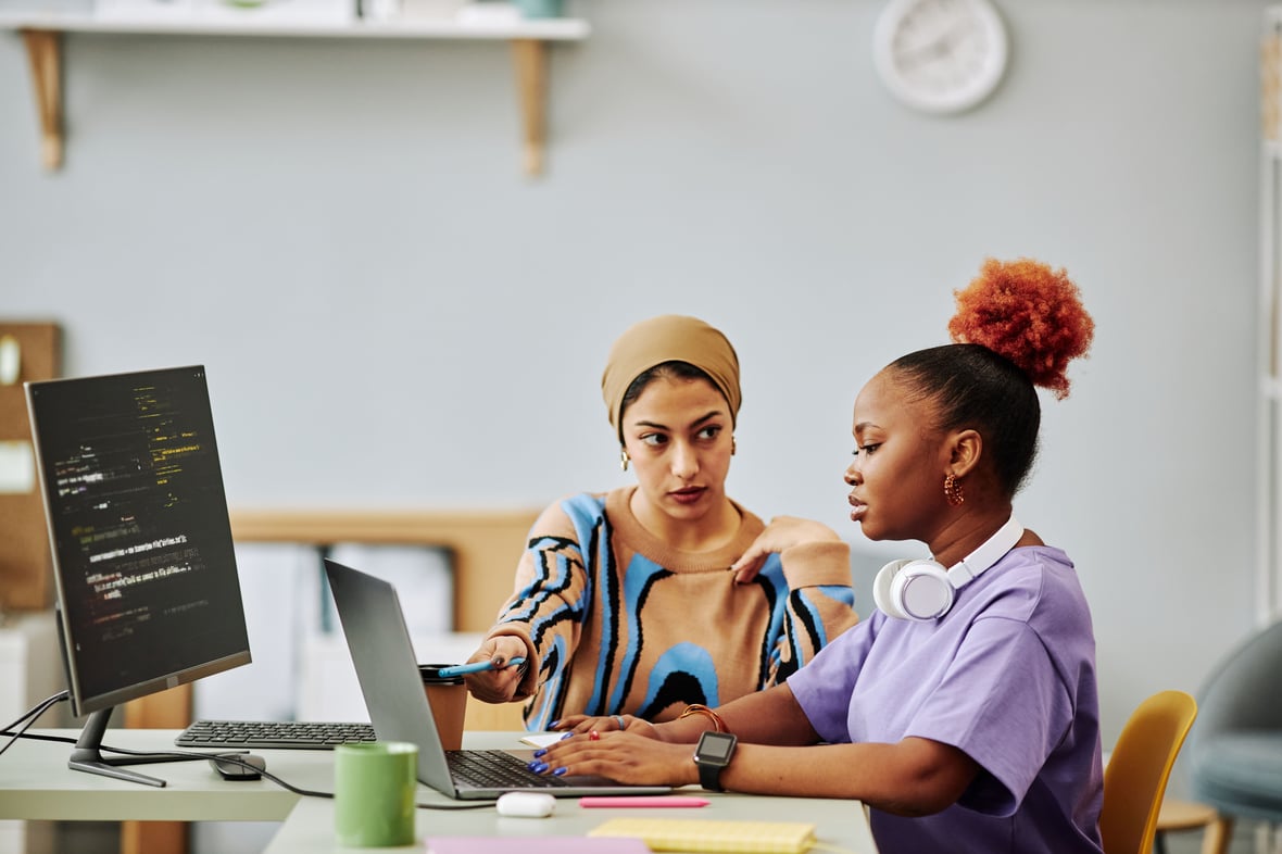 Two women at computer solving their low e-commerce conversion rate