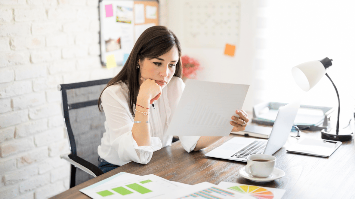 Marketer siting at her desk looking at reports