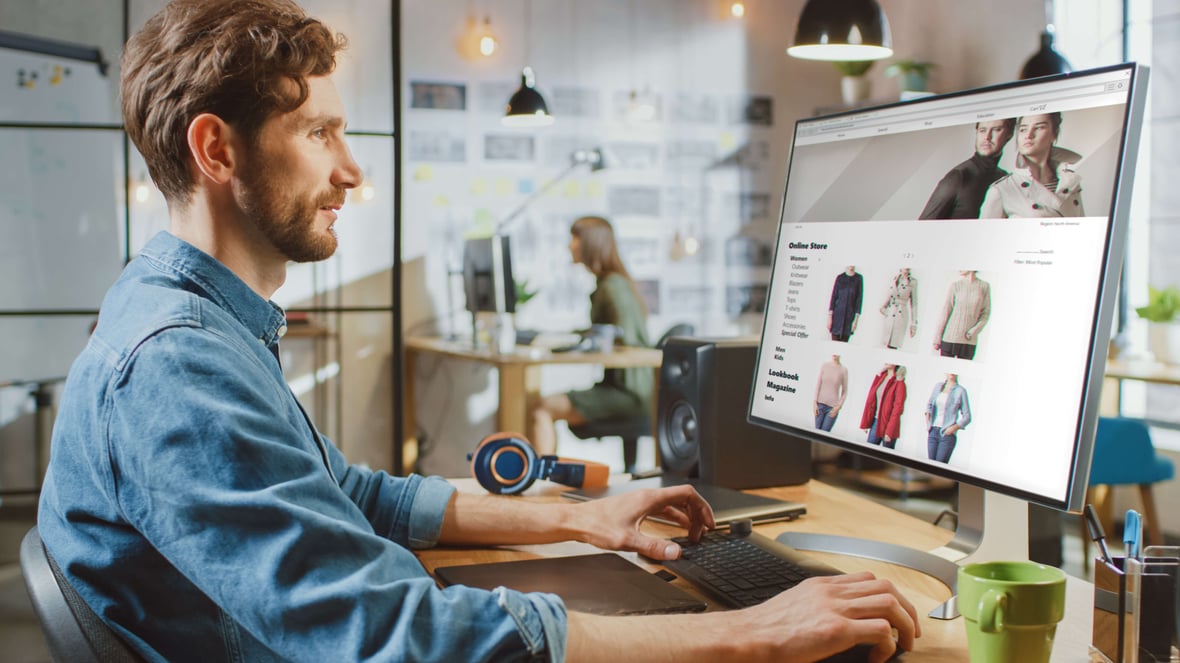 Man shopping on his computer for apparel on a custom Shopify store