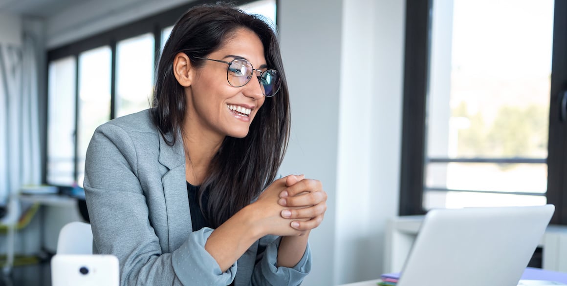 Woman attending webinar on laptop