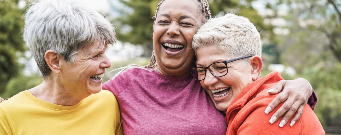 three senior women laughing together