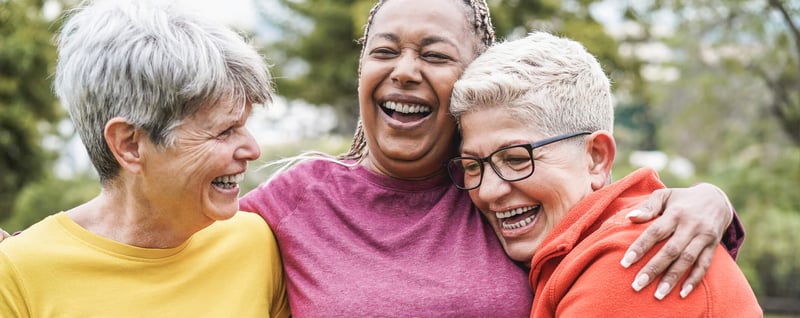 three senior women laughing together