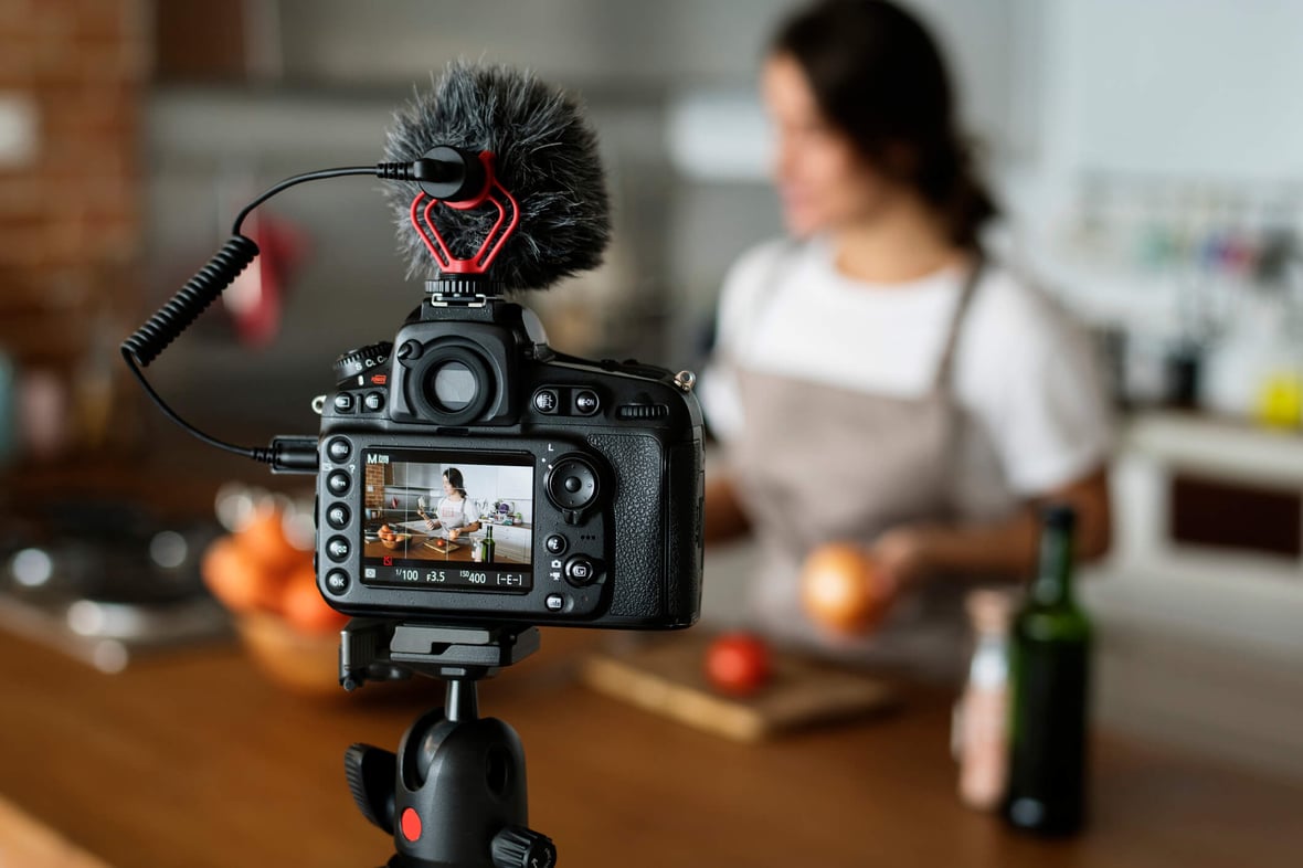 Person filming a video of cooking in a kitchen for SEO website content. 