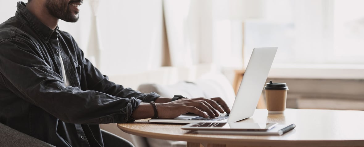 A man working on a laptop in his home office