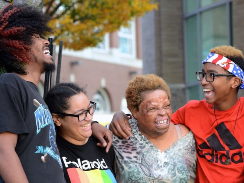 Four individuals laughing