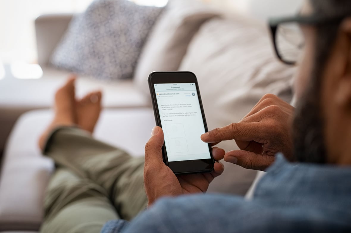 A man reading an email on his phone