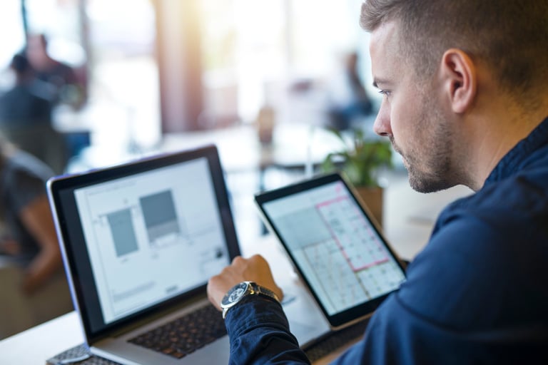 Man looking at his laptop while analyzing data