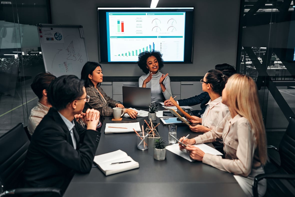 A group of marketers in a meeting analyzing data