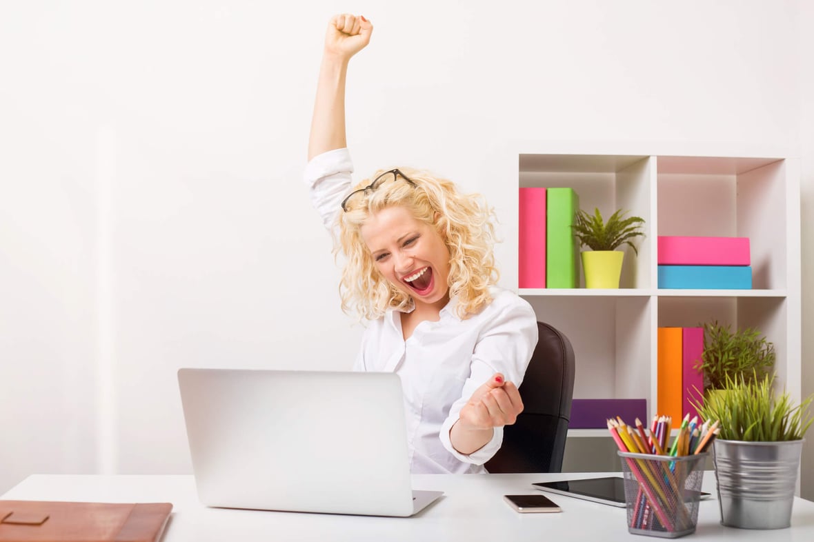 SmartBug designer celebrating at her laptop.