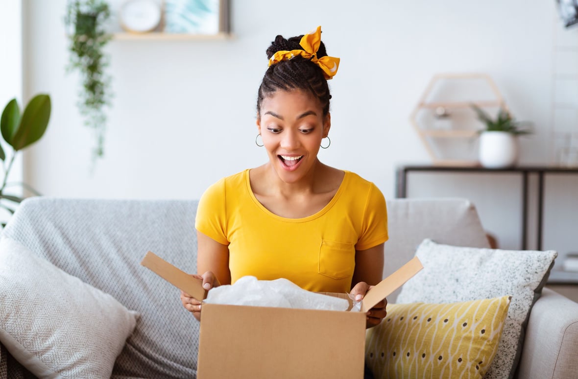 women unboxing a gift