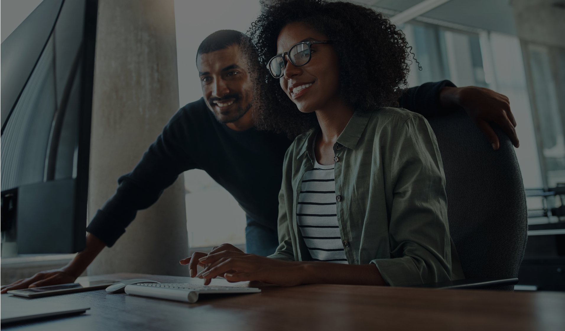 Two people looking a computer screen