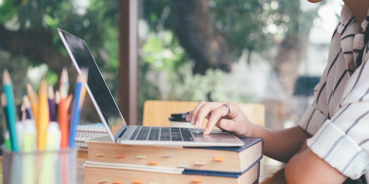 Close up image of a woman working on a laptop