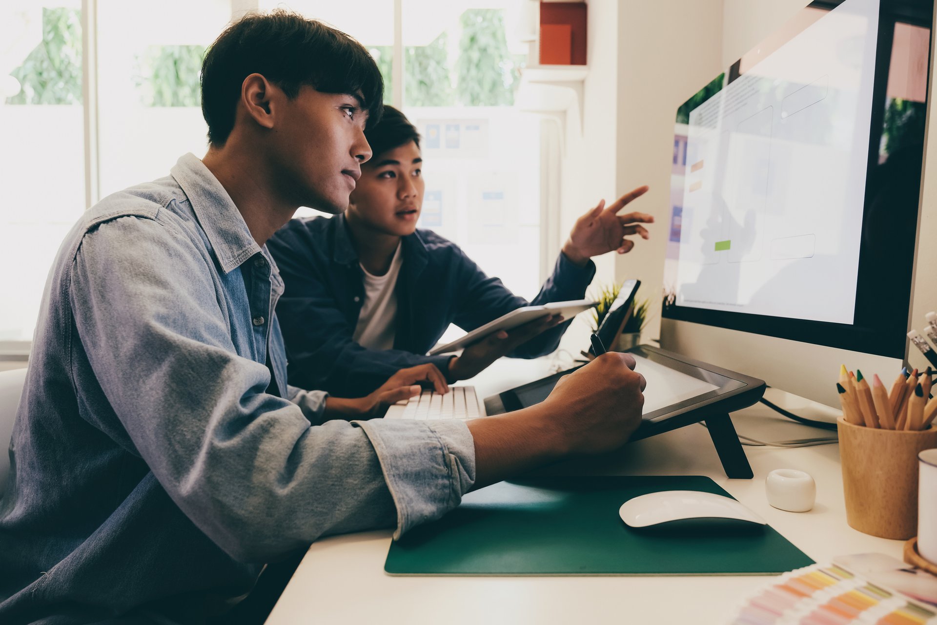 Two employees working at a computer