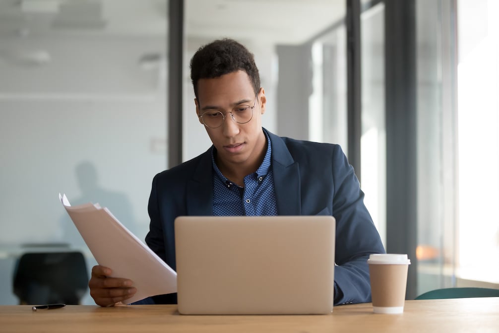 businessman reviewing attribution reports 