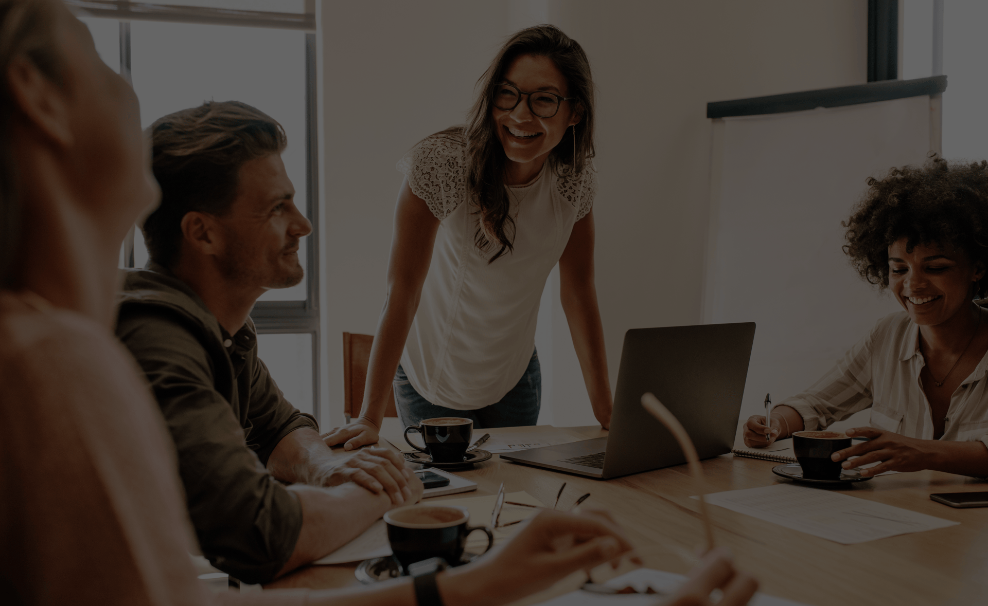 employees chatting around a desk