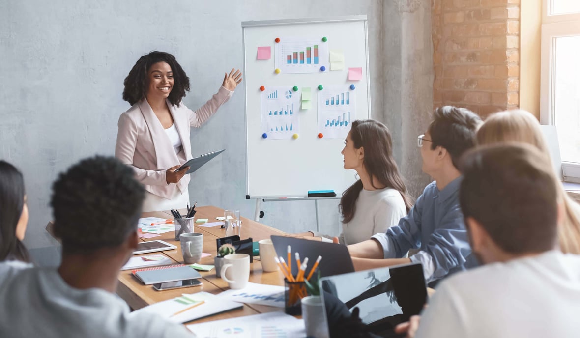 A group of marketing professionals listening to a manager 