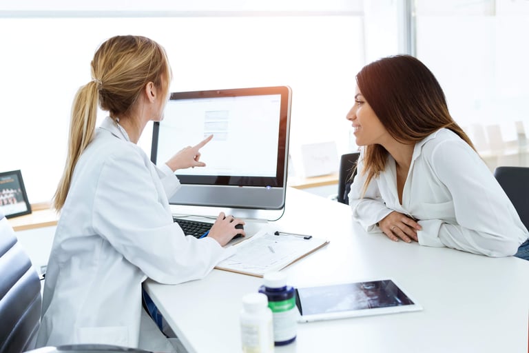 A doctor showing her patient information on her desktop