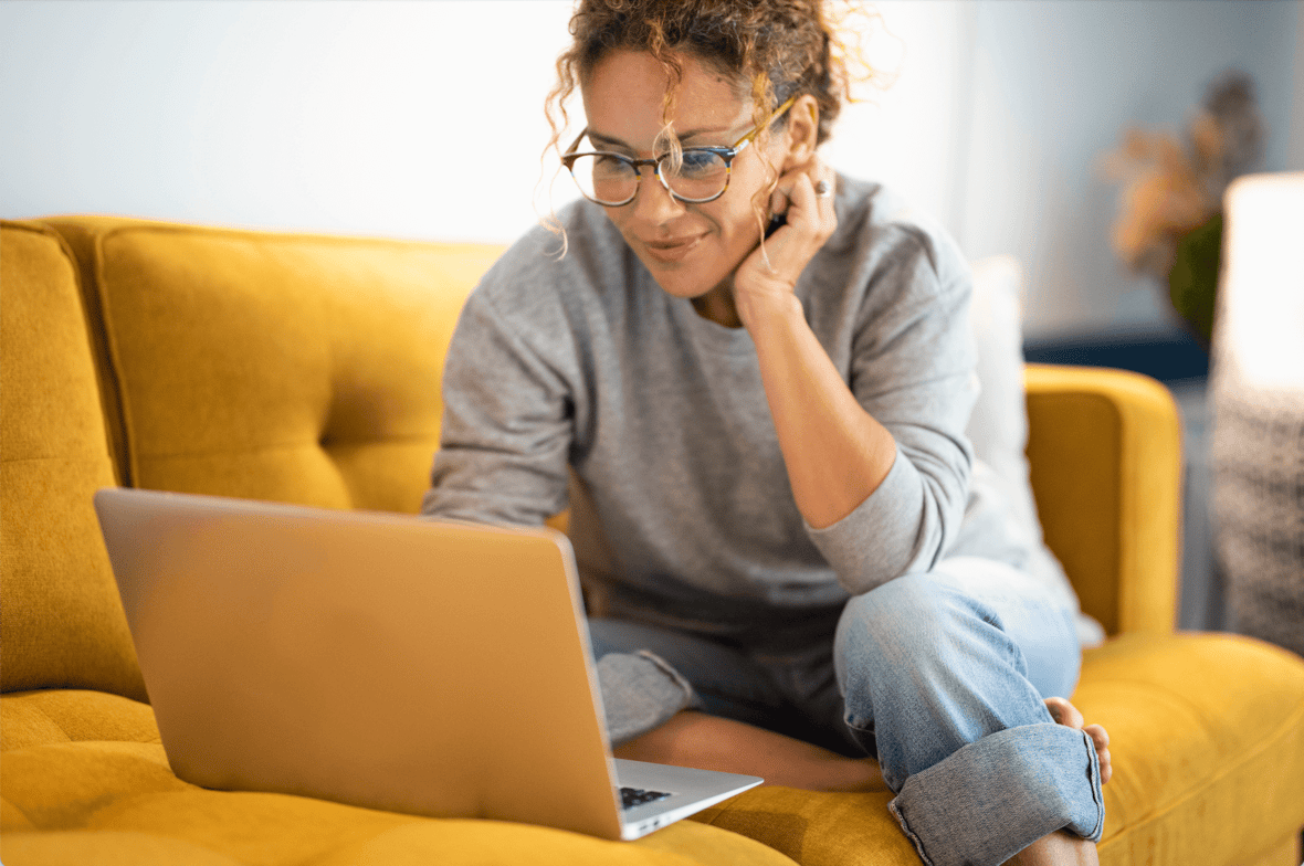 Woman sitting on a couch with her laptop