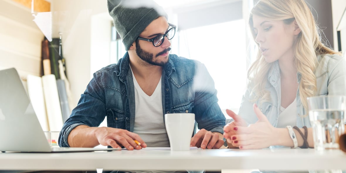 Two marketers discussing over coffee