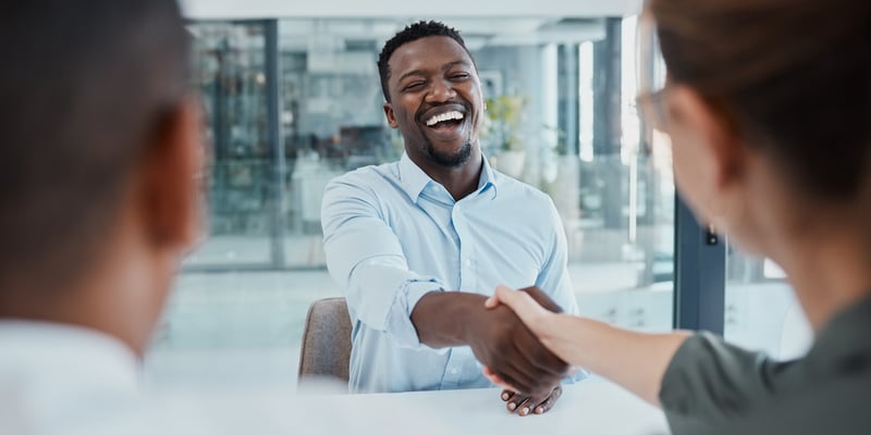Business owner shaking hands with a business client he earned through implementing B2B Inbound Marketing.