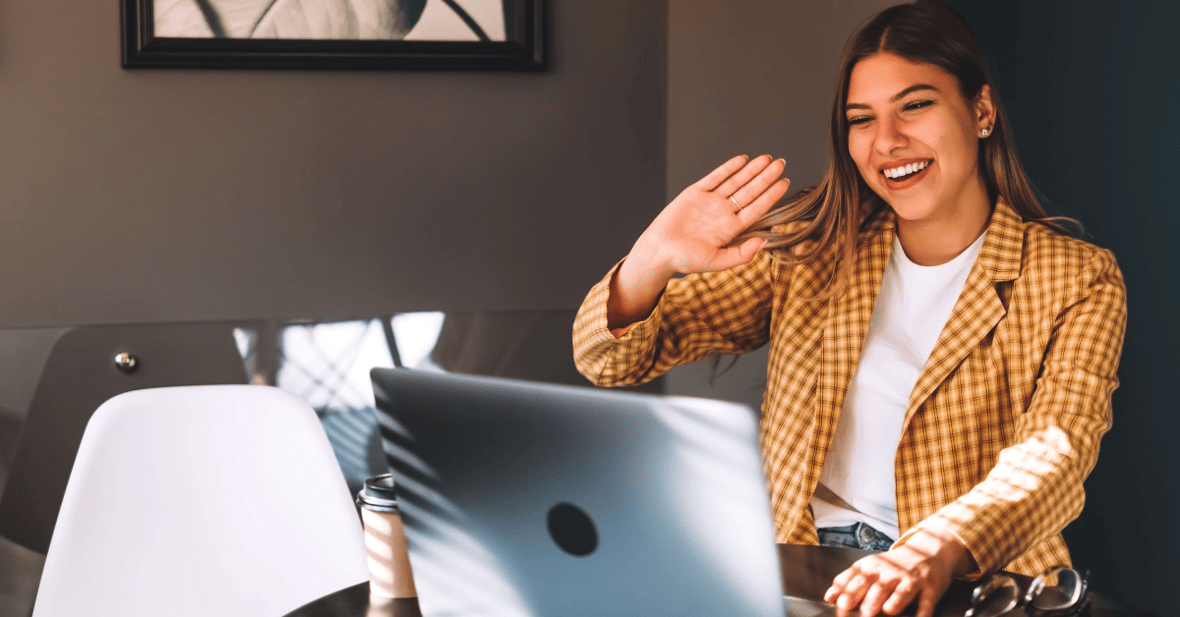 young woman smiling on zoom call on laptop