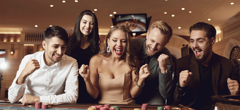 Group of people cheering and playing poker 