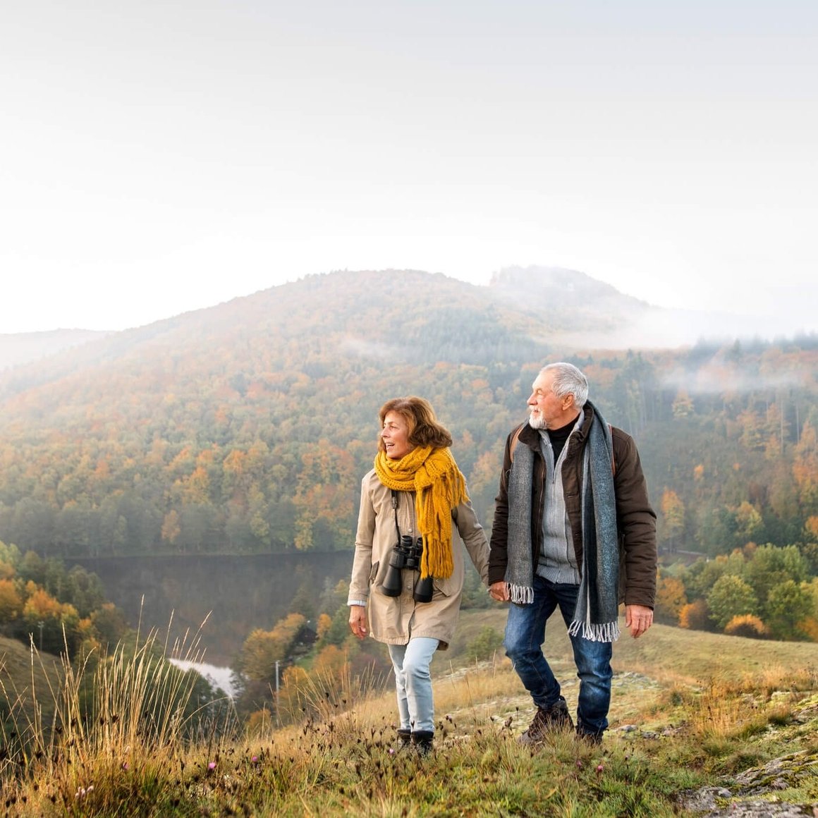 senior couple enjoying walk outdoors in autumn